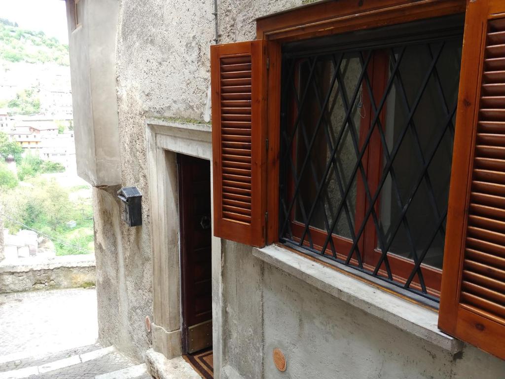 an open window of a building with a door at La Casa del Cuore in Scanno