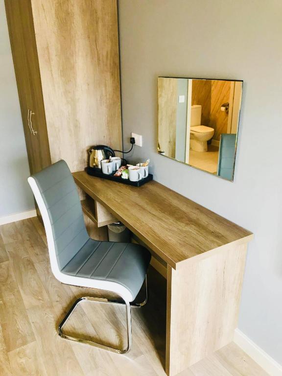a desk with a chair and a mirror at The Anchor Hotel & Bars in Ingoldmells