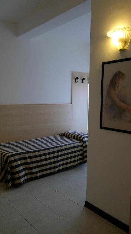 Postel nebo postele na pokoji v ubytování Hotel Erika
