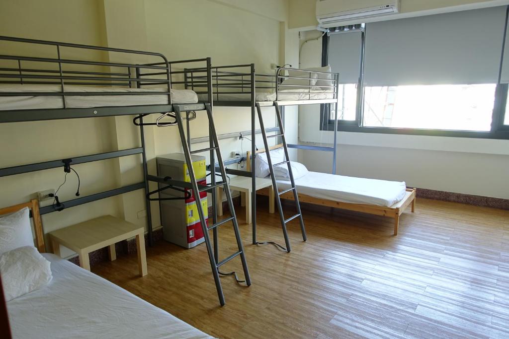 Postel nebo postele na pokoji v ubytování Chiayi Petite Hostel