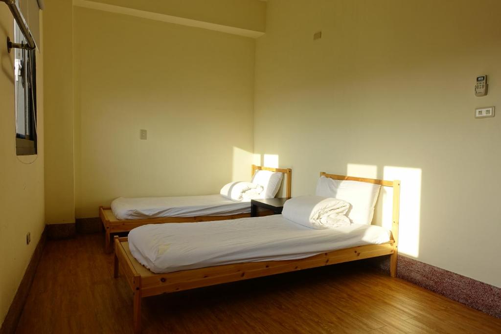 Postel nebo postele na pokoji v ubytování Chiayi Petite Hostel