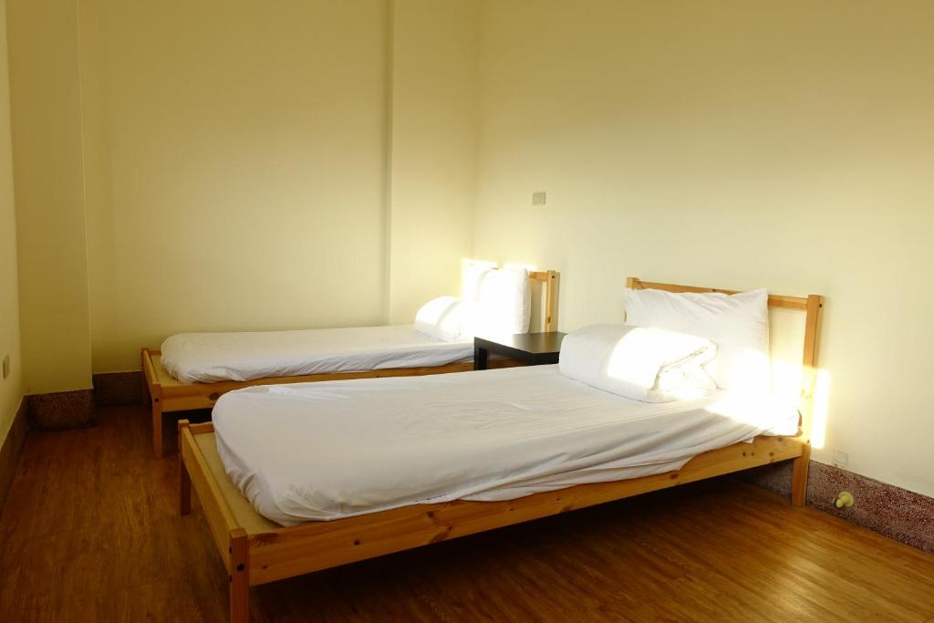 Postel nebo postele na pokoji v ubytování Chiayi Petite Hostel