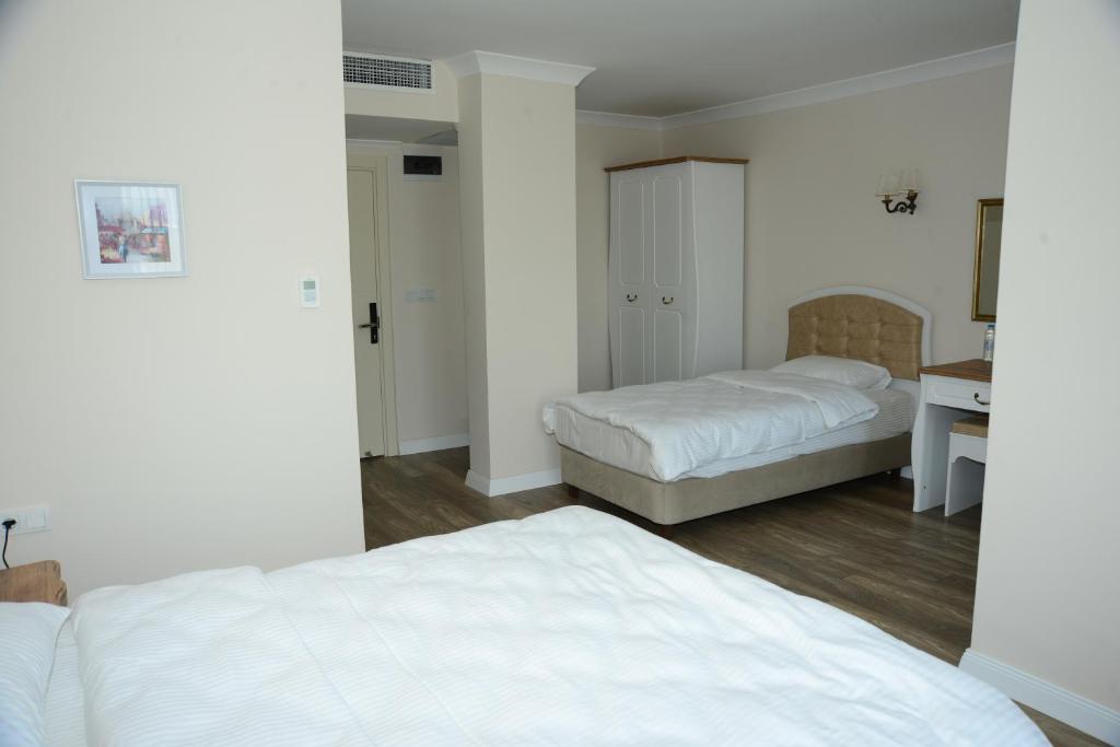 Postel nebo postele na pokoji v ubytování Casa Grande Otel