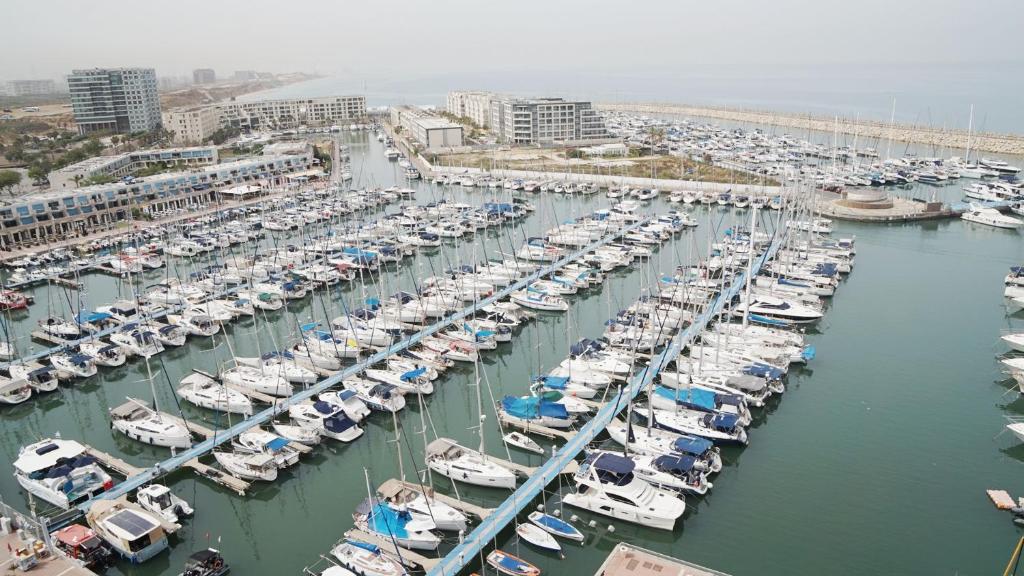 an aerial view of a harbor filled with boats at Marina Towers - Herzeliya in Herzelia 
