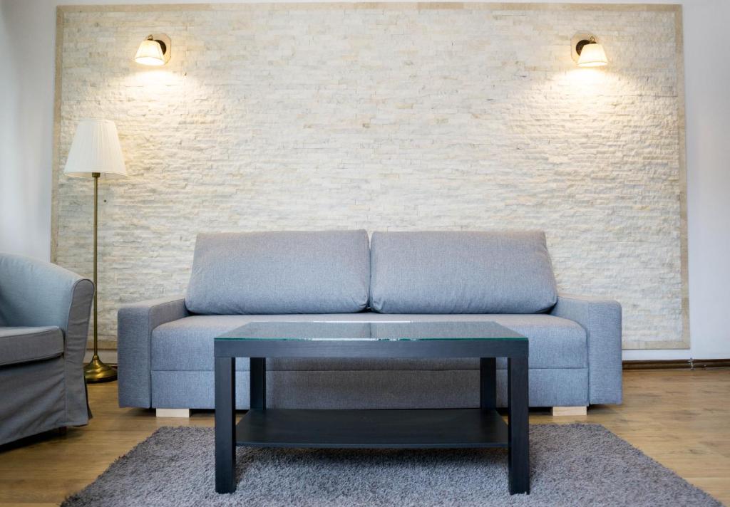 a living room with a couch and a table at Nest in Drobeta-Turnu Severin