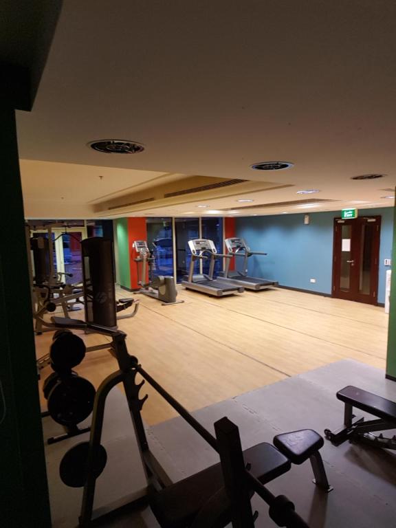 a gym with several treadmills and machines in a room at شقة استديو in King Abdullah Economic City