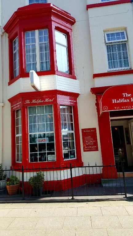 a red and white building on a street at The Halifax Hotel in Blackpool