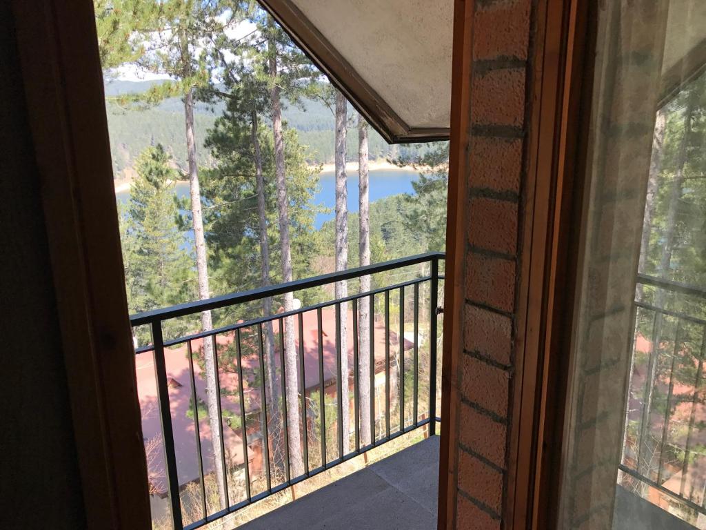 a room with a balcony with a view of a lake at Villaggio Palumbo Sila - Appartamento in Cotronei