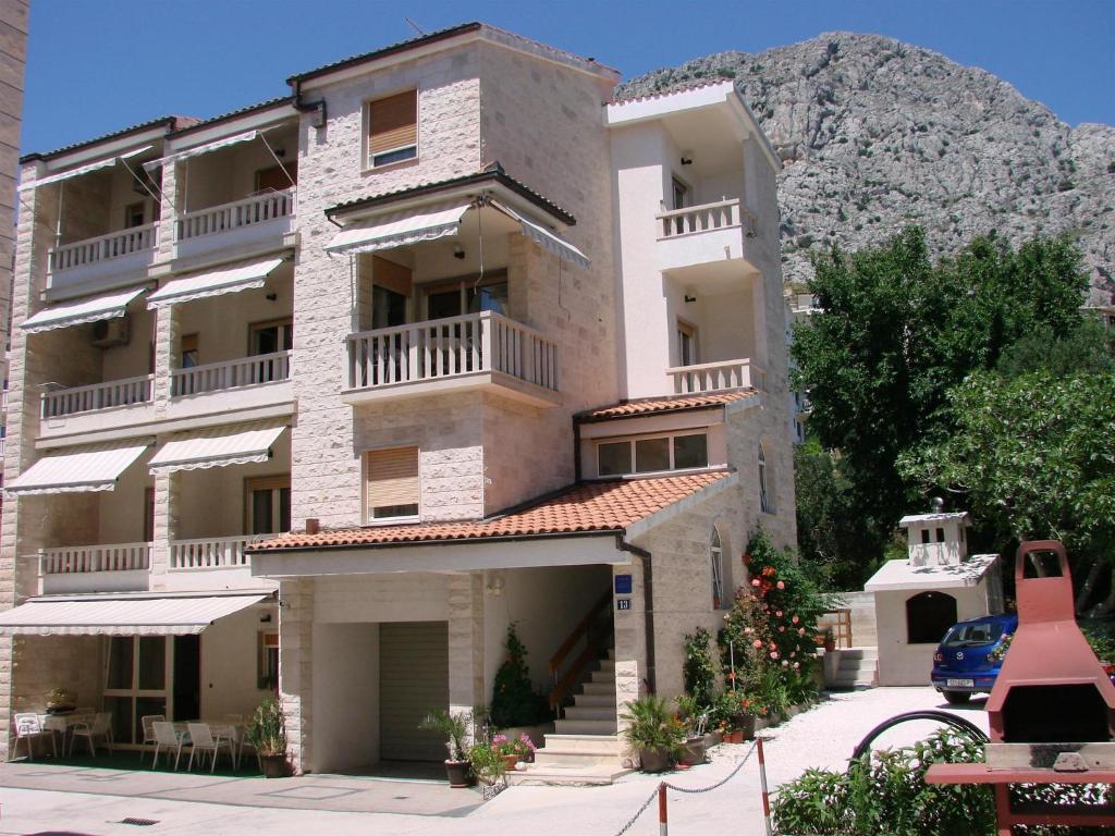 an apartment building with a mountain in the background at Villa Sladojević in Omiš