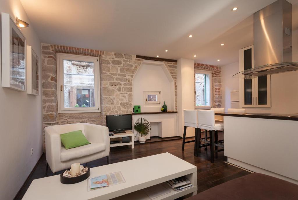 a living room with a couch and a table at Apartment Istra in Rovinj