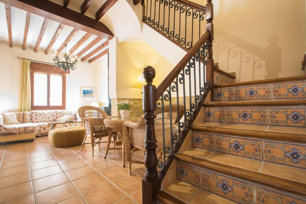 a living room with a staircase and a table at Casa La Font in Aigues