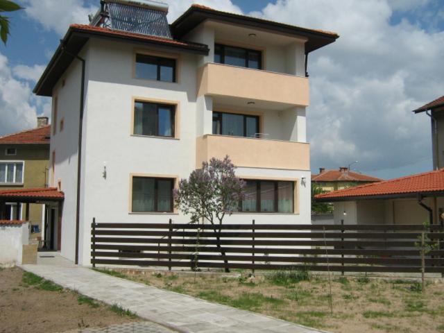 a large white house with a fence in front of it at Khan Krum House & Apartments for rent in Elin Pelin