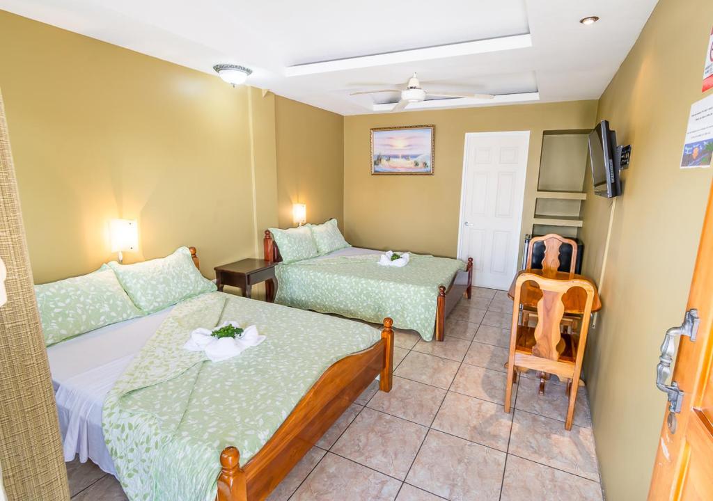 Postel nebo postele na pokoji v ubytování Hotel Le Priss