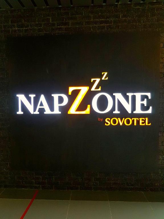 a sign that says nz zone on a wall at Sovotel @ Napzone KKIA in Kota Kinabalu