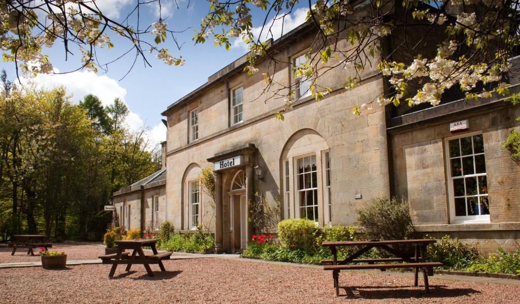 a building with benches in front of it at Bankton House in Livingston