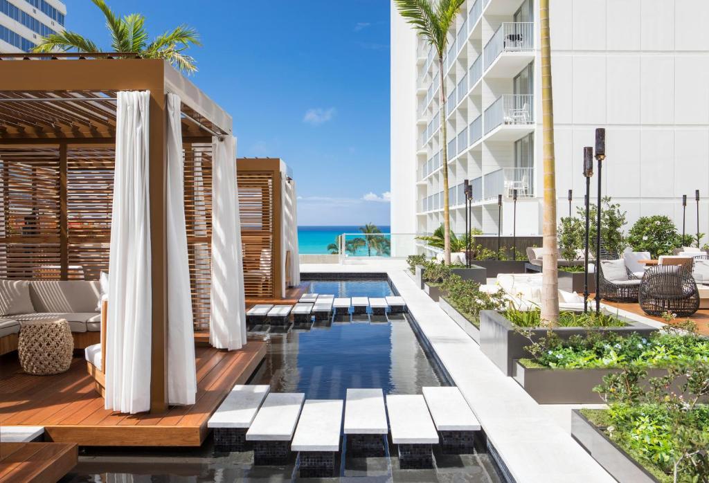 an outdoor pool with a view of the ocean at 'Alohilani Resort Waikiki Beach in Honolulu