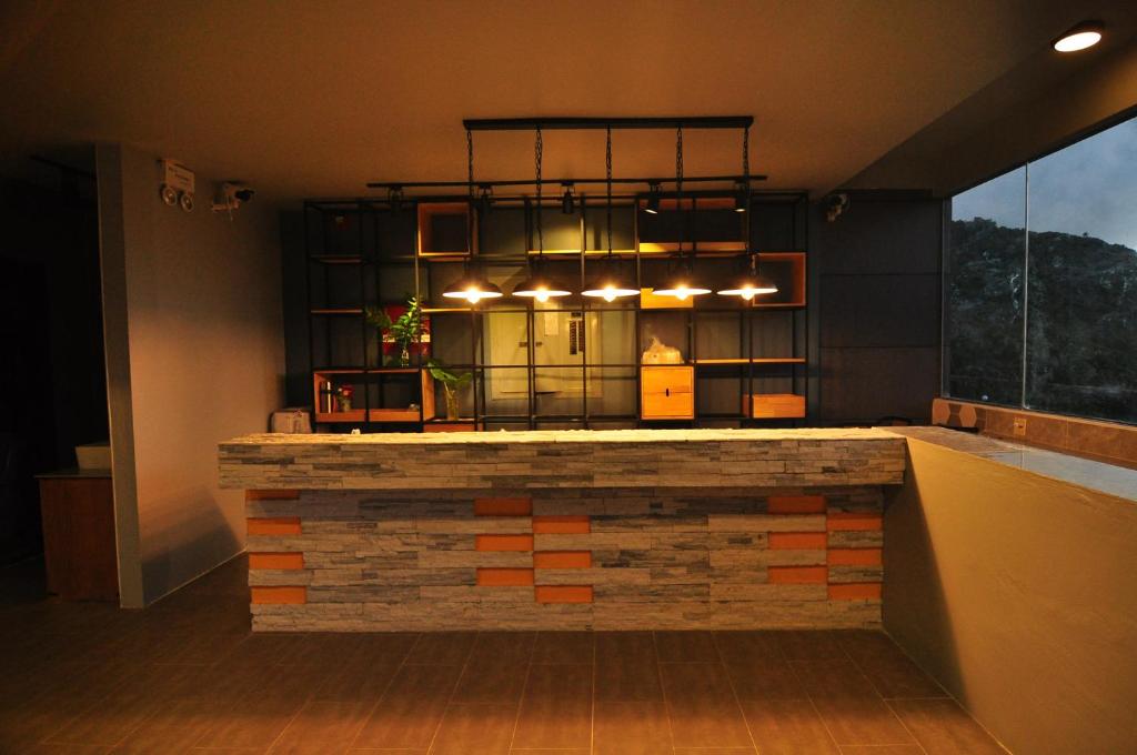 a bar in a room with a brick wall at Saipan Skyline Designers Hotel in Saipan