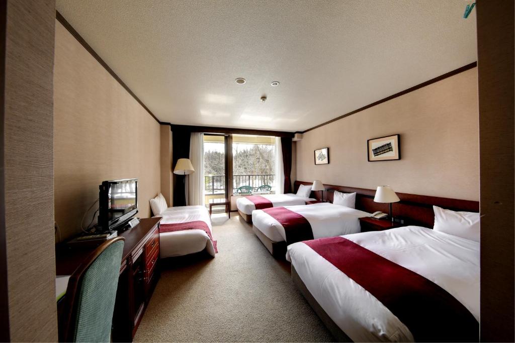 Postel nebo postele na pokoji v ubytování Hakuba Mominoki Hotel