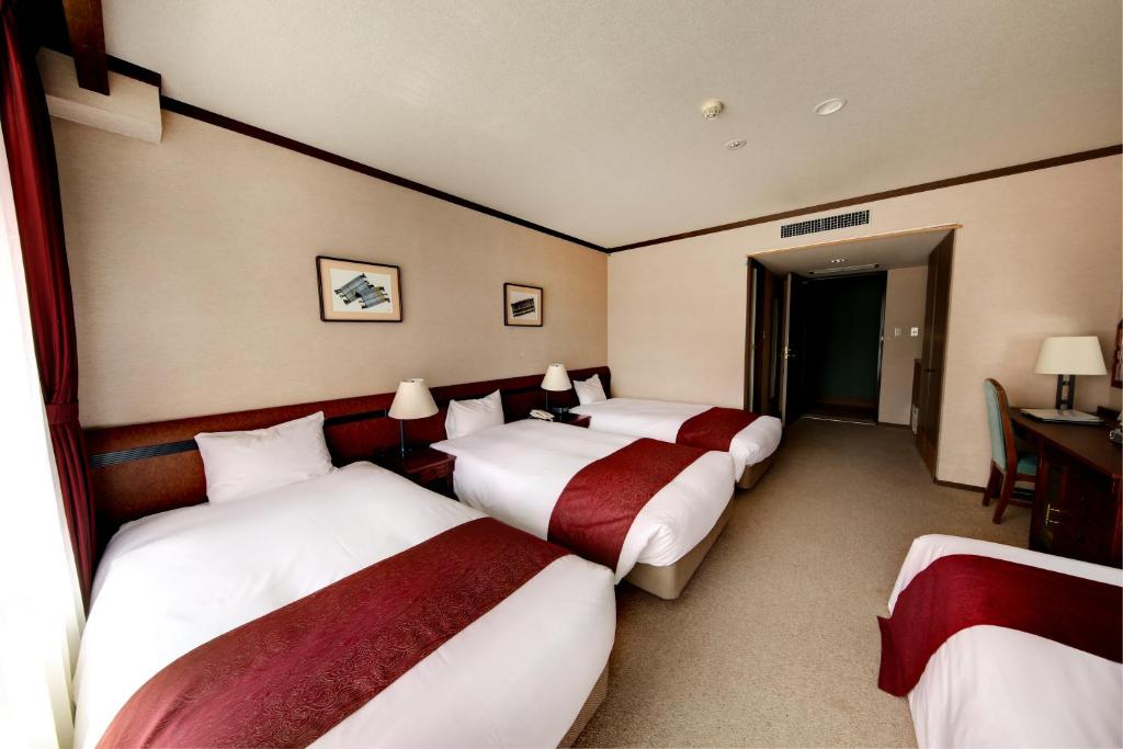 Postel nebo postele na pokoji v ubytování Hakuba Mominoki Hotel
