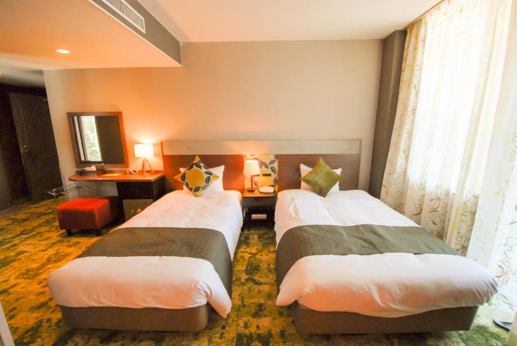 Postel nebo postele na pokoji v ubytování Hakuba Mominoki Hotel