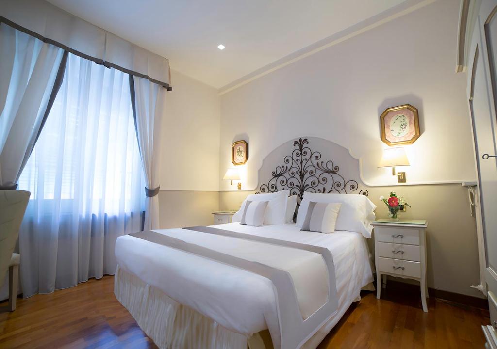 Postel nebo postele na pokoji v ubytování Hotel Jolanda