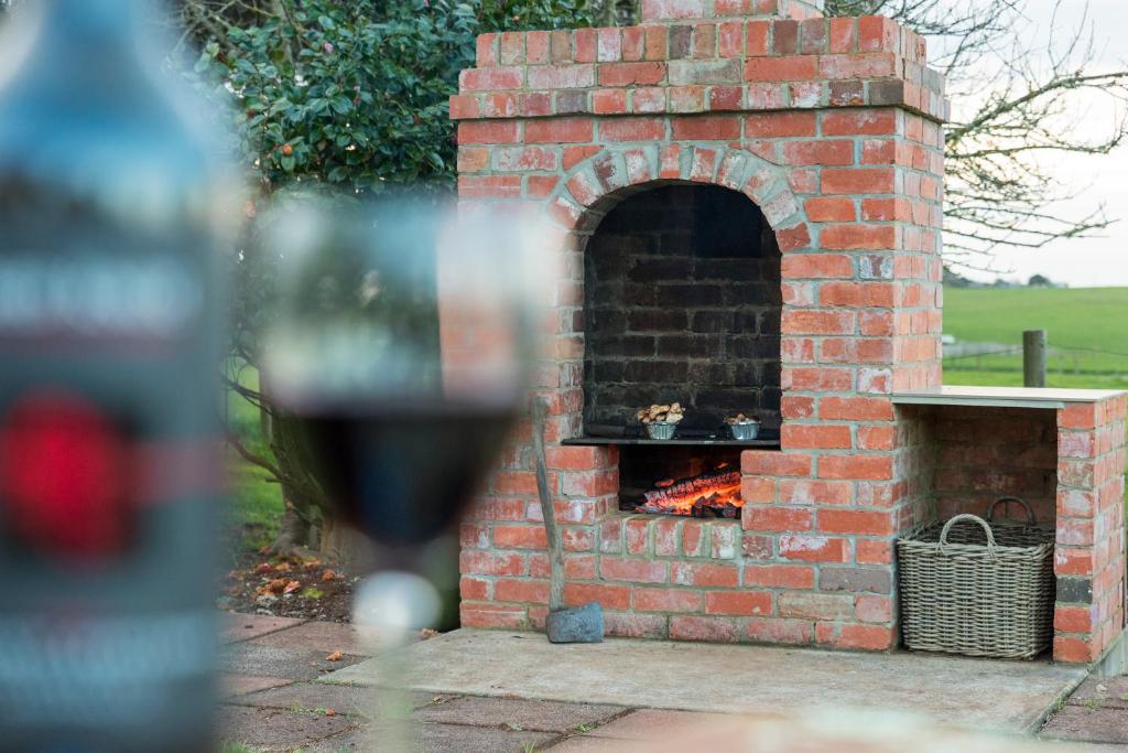 a brick oven with a fire in it at Killynaught Spa Cottages in Boat Harbour