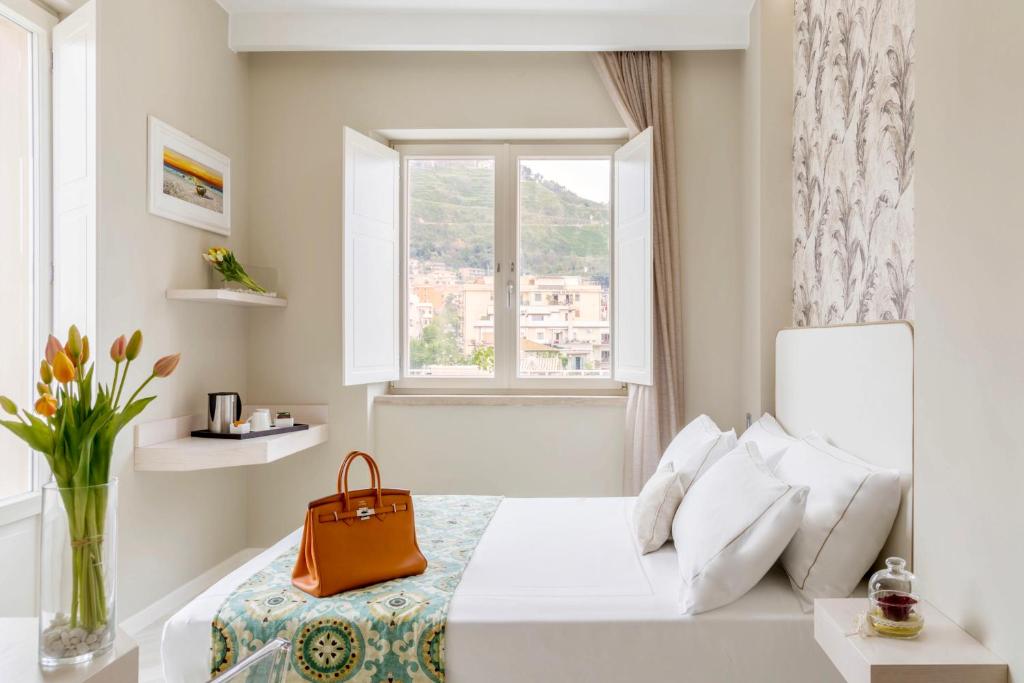 Łóżko lub łóżka w pokoju w obiekcie Townhouse Tropea