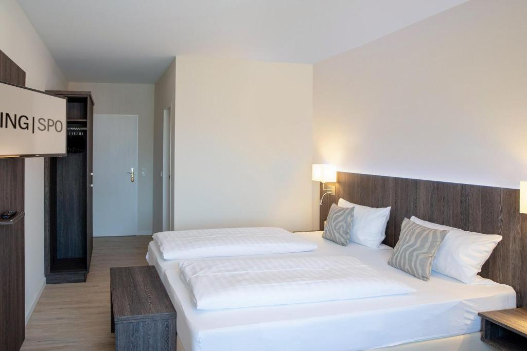 Postel nebo postele na pokoji v ubytování Hotel Twilling