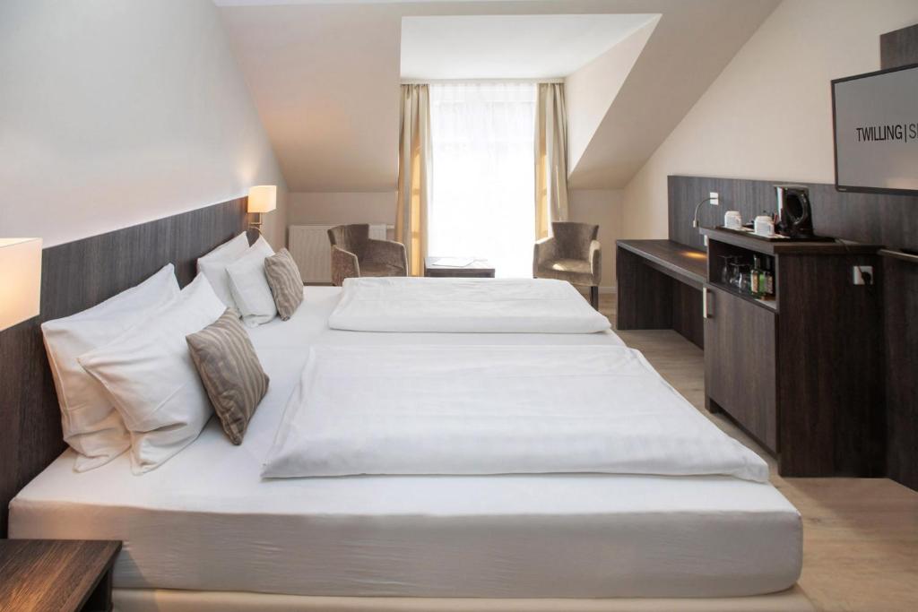 Postel nebo postele na pokoji v ubytování Hotel Twilling