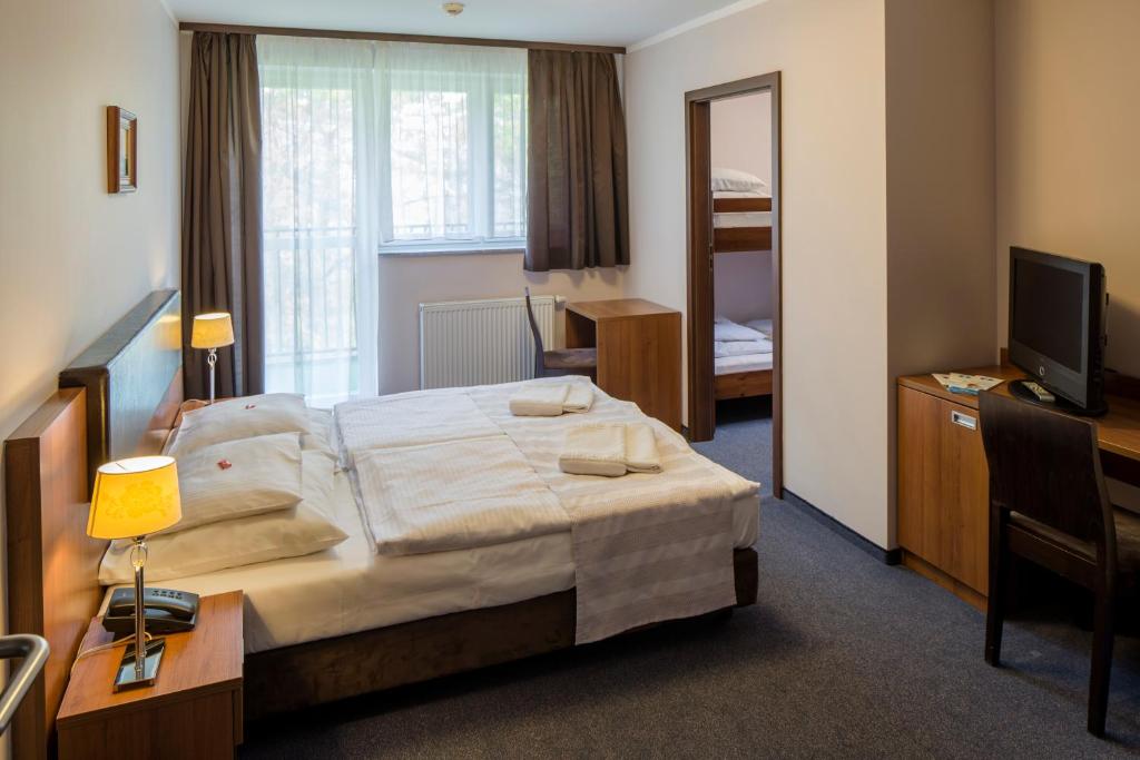 Postel nebo postele na pokoji v ubytování Maximus Spa