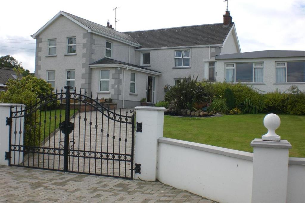 a large white house with a gate in front of it at Beau Vista in Strabane