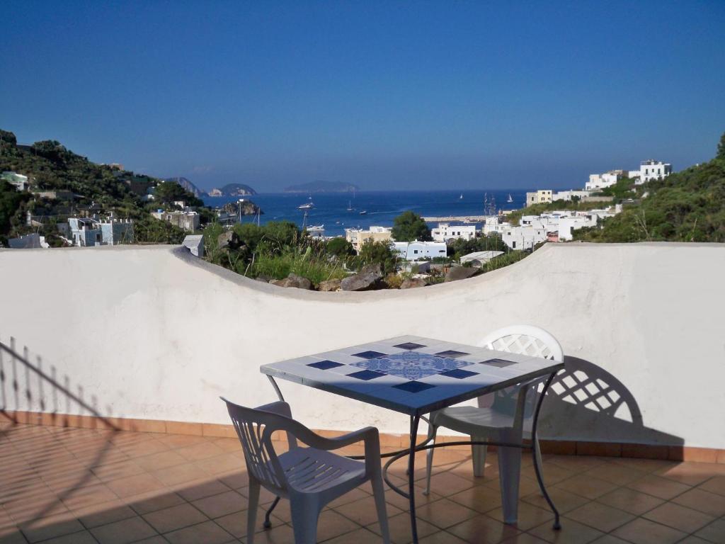 a table and two chairs on a balcony with a view at L'Isolana Case Vacanza Luna 1 in Ponza