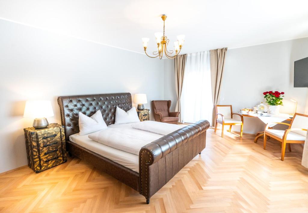 a bedroom with a bed with a leather bed frame at Altstadt Liebling in Vöcklabruck