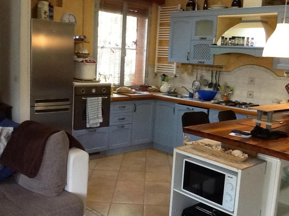 a kitchen with blue cabinets and a counter top at Villetta orchidea in Rimini