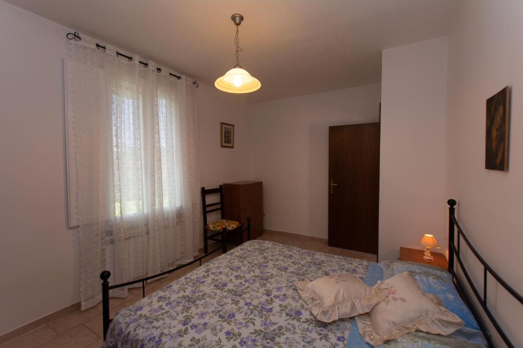 Postel nebo postele na pokoji v ubytování Appartamenti Massarella
