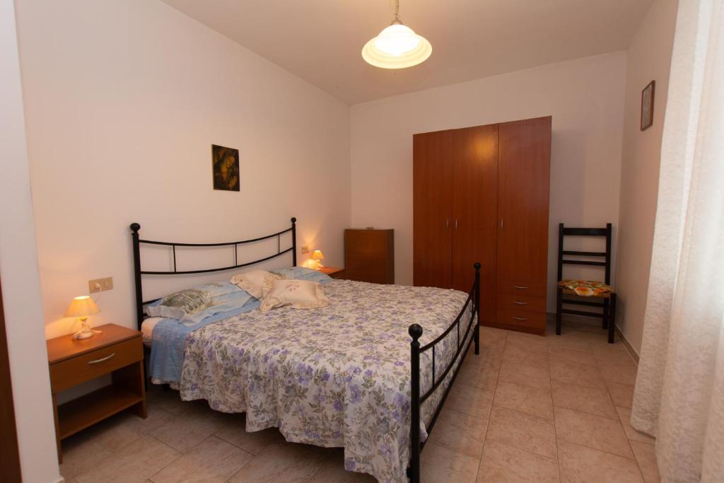 Postel nebo postele na pokoji v ubytování Appartamenti Massarella