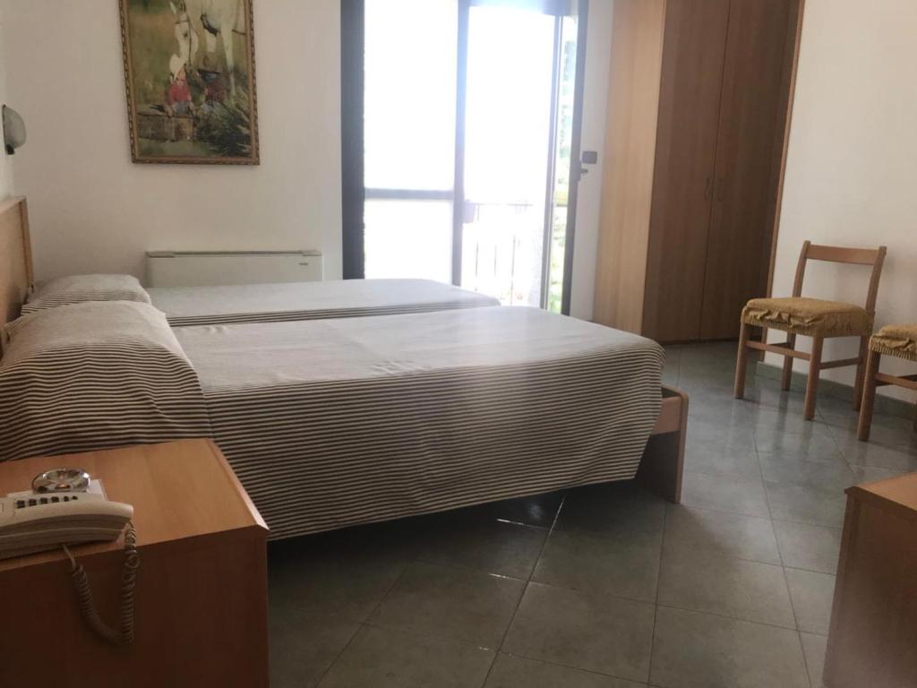 Posteľ alebo postele v izbe v ubytovaní Hotel Cristallo