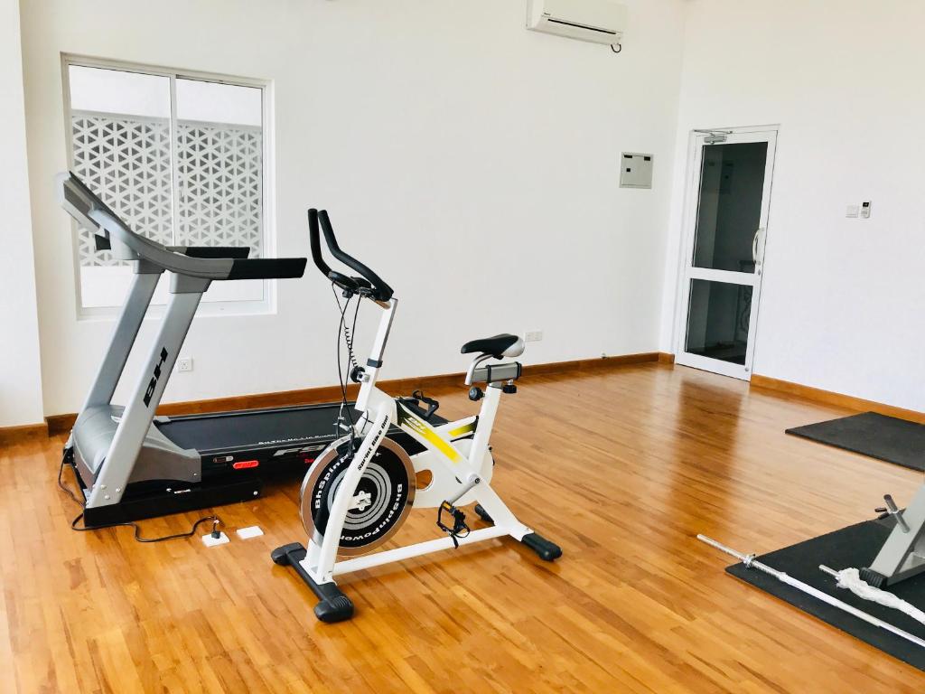 a gym with a treadmill and a exercise bike at Araliya OceanFront Condos Nilaveli, Trincomalee in Nilaveli