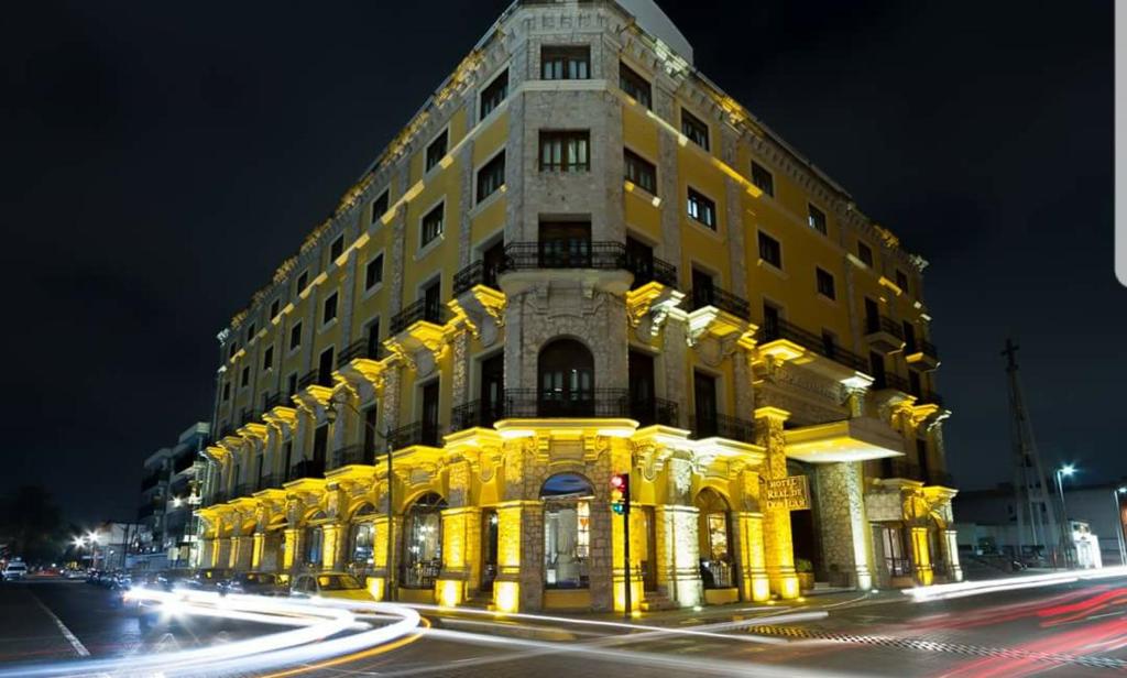 a yellow building with lights on the side of it at Hotel Real de Don Juan in Tepic