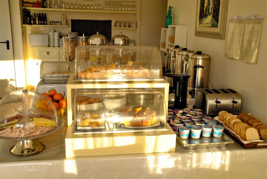 a counter with a display of food and pastries at Hotel Villa Fiorita in Sorrento