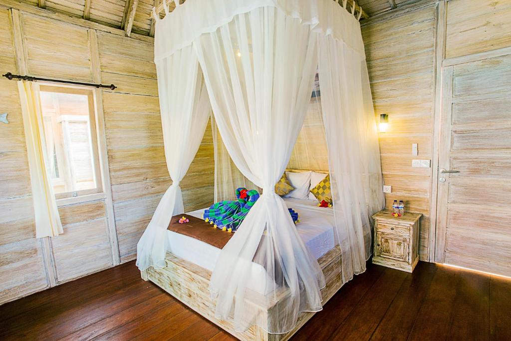 Een bed of bedden in een kamer bij Secret Point Huts