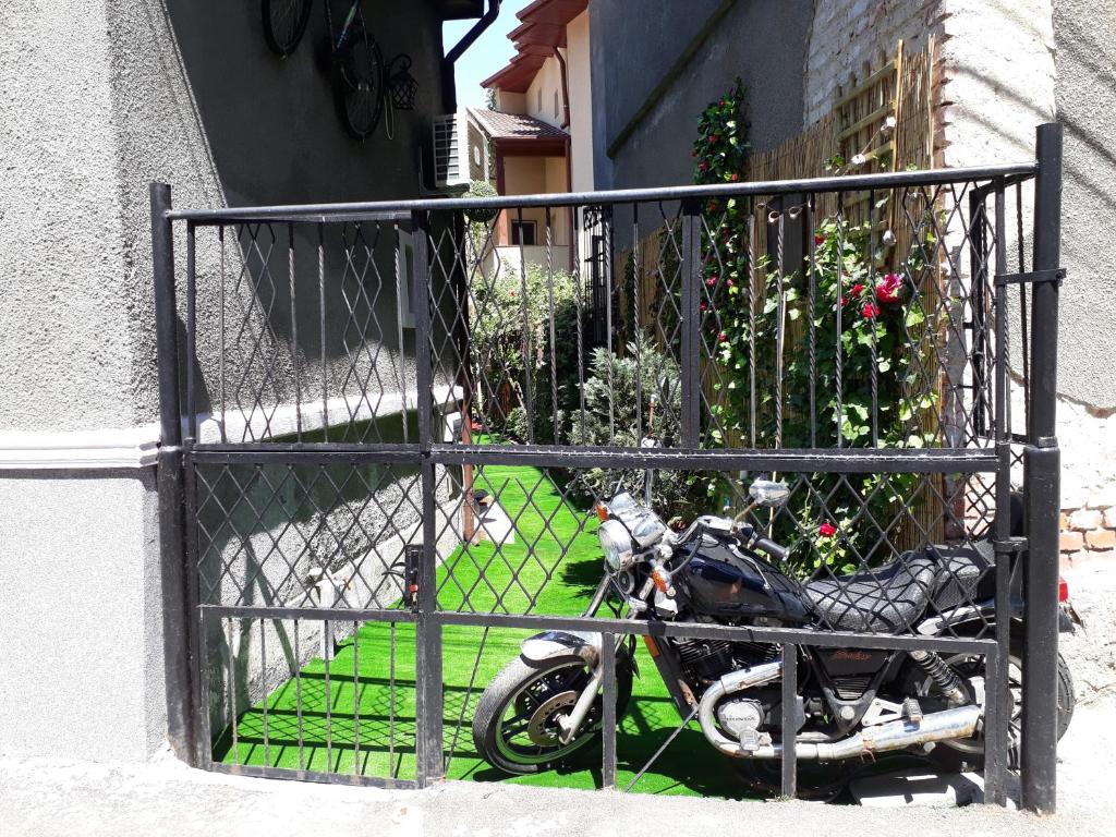 a motorcycle parked in front of a gate at Motor House Unirii in Bucharest
