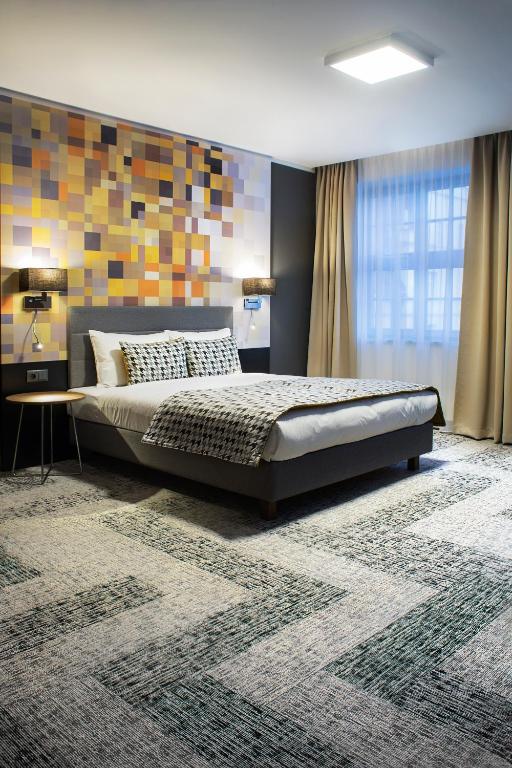 Postel nebo postele na pokoji v ubytování IBB Hotel Gdańsk