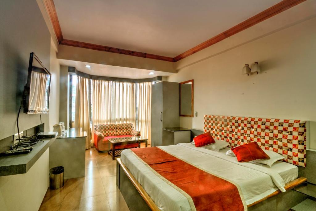 a hotel room with a bed and a kitchen at Hotel Gateway Shillong in Shillong