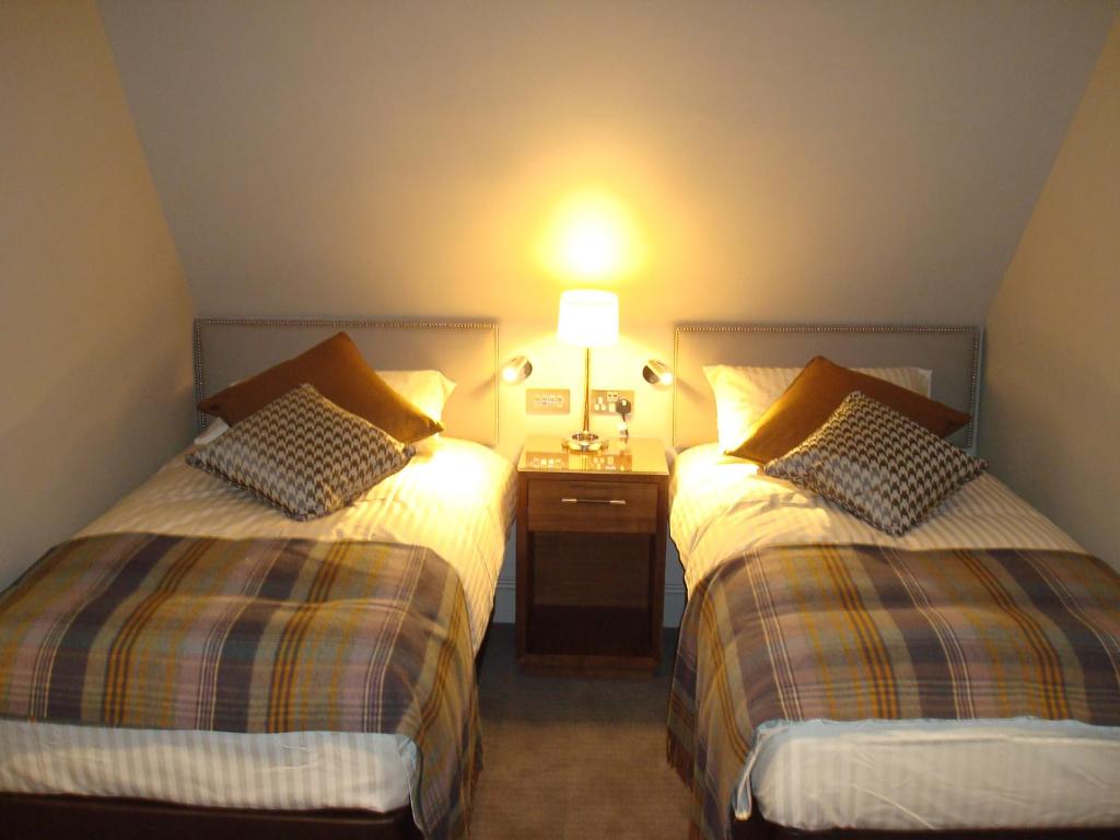 Postel nebo postele na pokoji v ubytování Cruachan Hotel