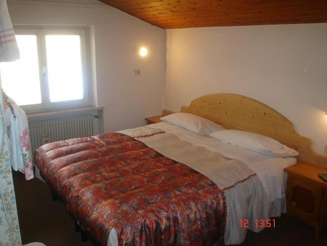 Łóżko lub łóżka w pokoju w obiekcie Garnì Villa Cecilia
