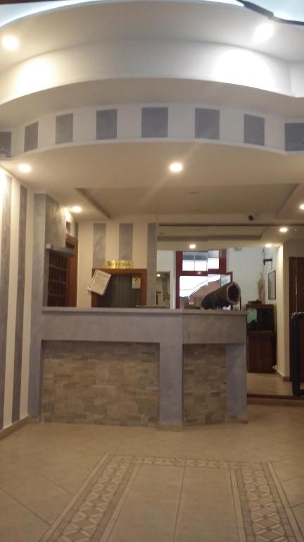 a lobby with a stone counter in a building at Hotel San Giorgio in Alassio