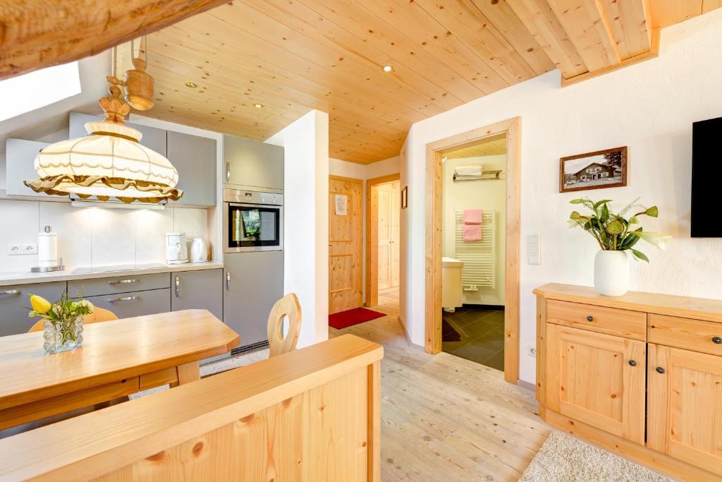 a kitchen with wooden floors and a wooden ceiling at Appartement Zentral de Luxe by A-Appartments in Brand