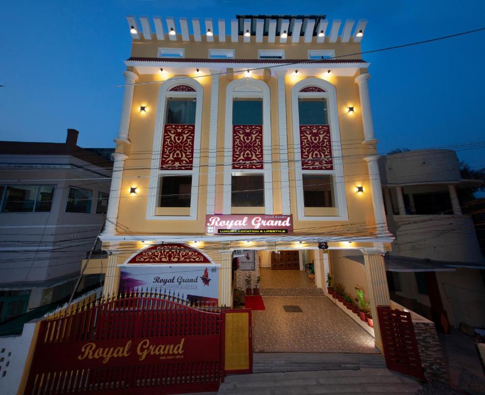 a large white building with a sign on it at Royal Grand in Tambaram