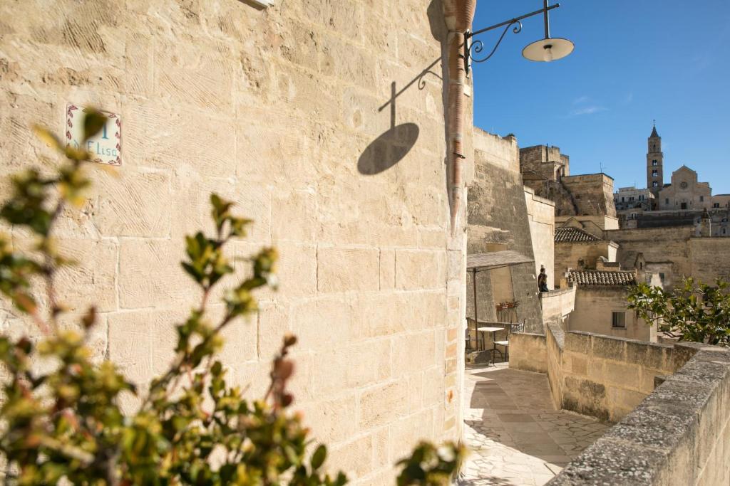 an alley in an old town with a building at Locanda Di San Martino Hotel & Thermae Romanae in Matera